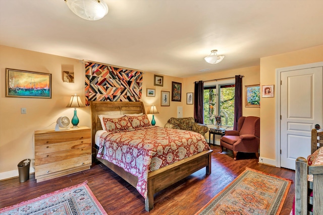 bedroom with dark hardwood / wood-style floors