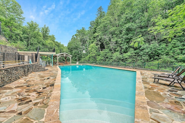 view of swimming pool with a gazebo and a patio