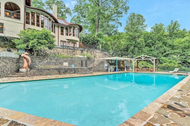 view of pool featuring a gazebo and a diving board