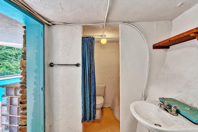 bathroom with toilet and sink