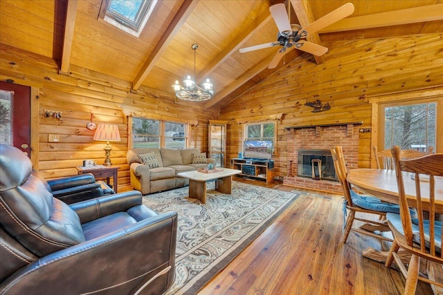 living room featuring hardwood / wood-style flooring, wood walls, high vaulted ceiling, and beamed ceiling