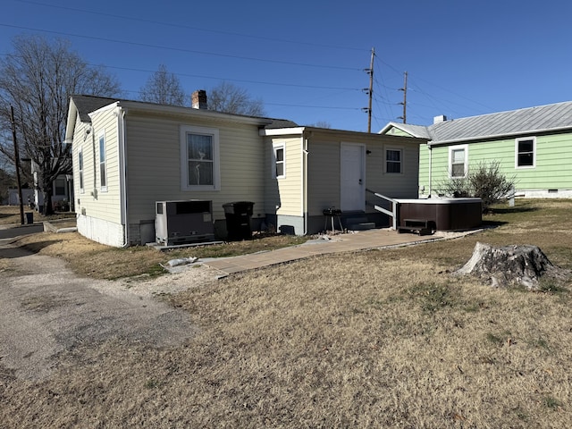 back of house with central air condition unit