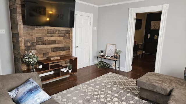 living room with dark hardwood / wood-style flooring and crown molding