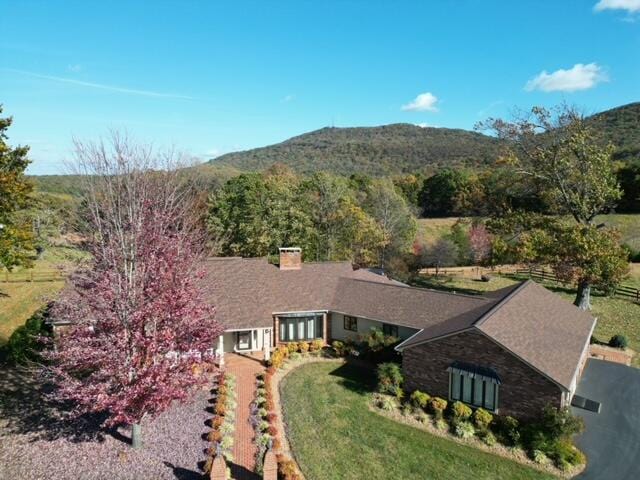 birds eye view of property with a mountain view