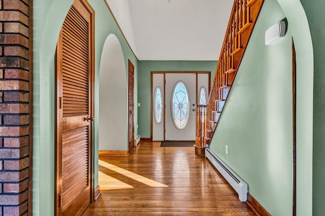 foyer with hardwood / wood-style floors and a baseboard radiator