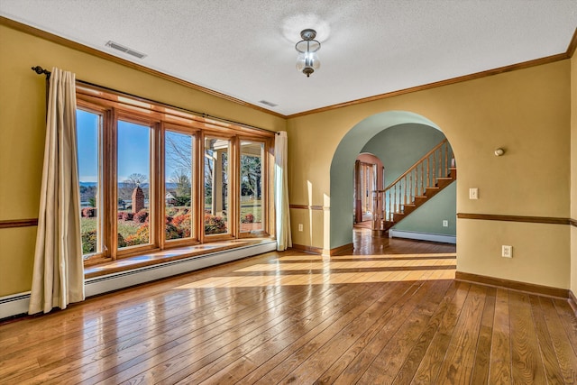 unfurnished room with hardwood / wood-style floors, a healthy amount of sunlight, and a baseboard radiator