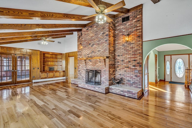 unfurnished living room featuring french doors, light hardwood / wood-style flooring, ceiling fan, built in features, and baseboard heating