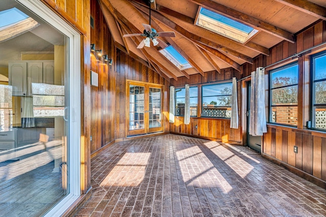 unfurnished sunroom featuring ceiling fan and vaulted ceiling