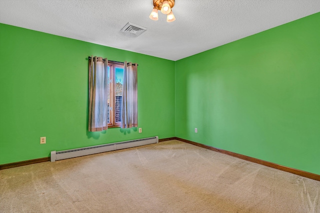 empty room with light colored carpet, a textured ceiling, and a baseboard heating unit