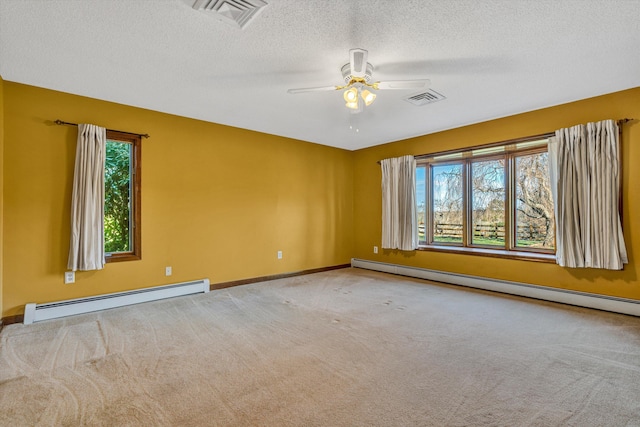 carpeted spare room featuring a textured ceiling, ceiling fan, and a baseboard heating unit