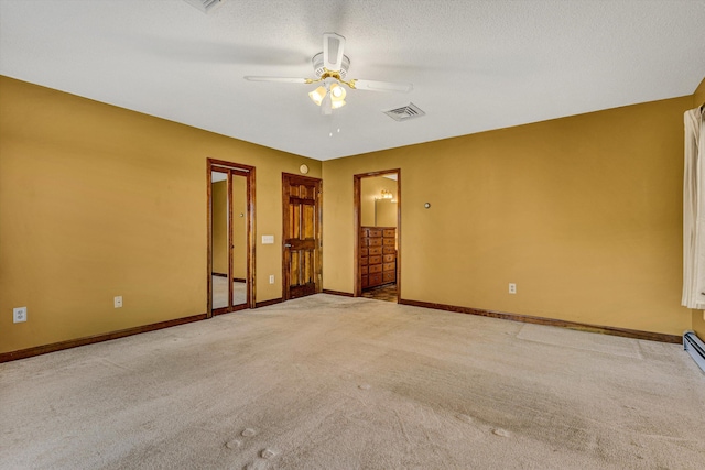 carpeted empty room featuring a textured ceiling and ceiling fan