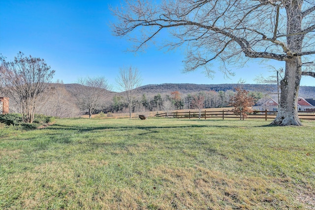 view of yard with a mountain view and a rural view