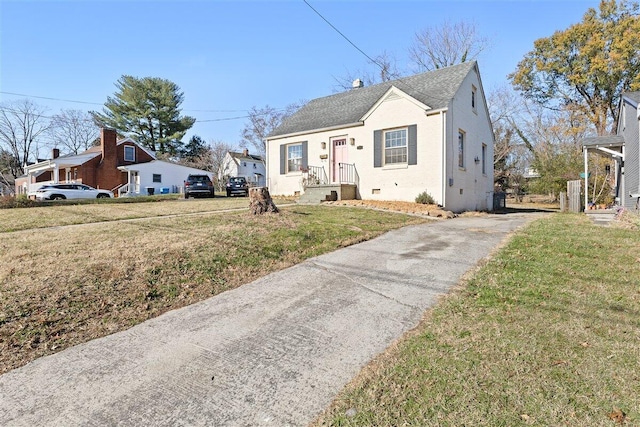 bungalow-style home with a front lawn