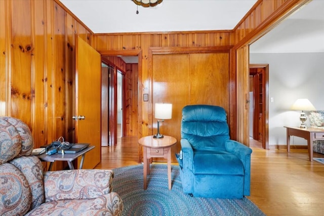 sitting room featuring light hardwood / wood-style flooring and wood walls