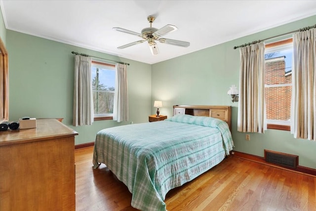 bedroom with ceiling fan and hardwood / wood-style flooring