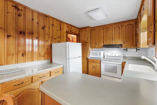 kitchen featuring sink, extractor fan, and white appliances