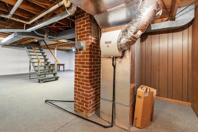 basement with carpet flooring and wooden walls