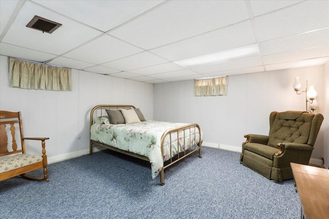 bedroom featuring a paneled ceiling and carpet