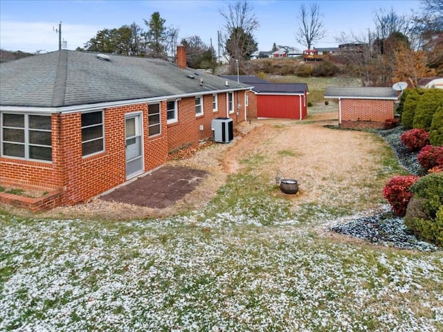 back of property featuring central AC