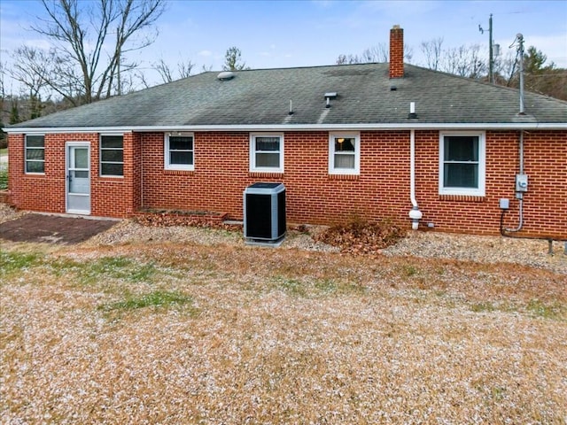 rear view of property featuring central AC