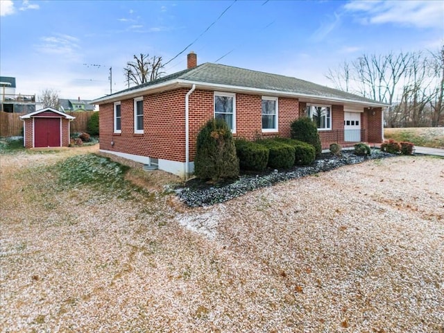 view of front of home with a storage shed