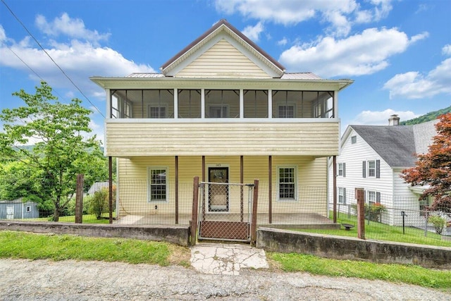 view of front of home featuring a patio area and a sunroom