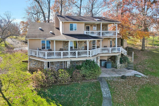 rear view of house featuring central AC unit