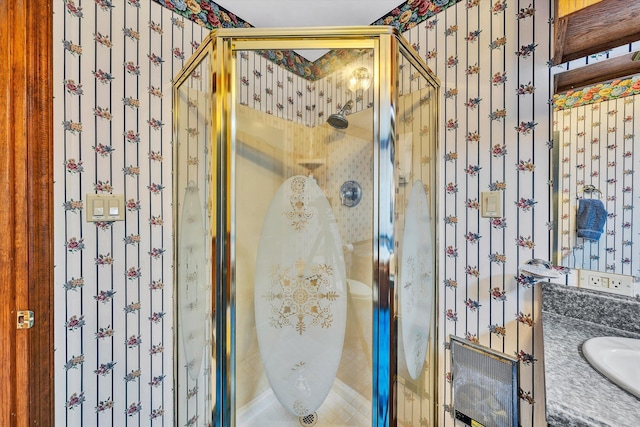 bathroom featuring vanity and a shower with shower door