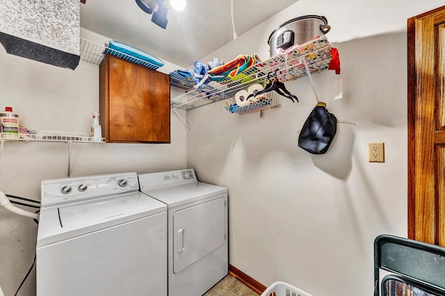 washroom featuring cabinets and washer and dryer