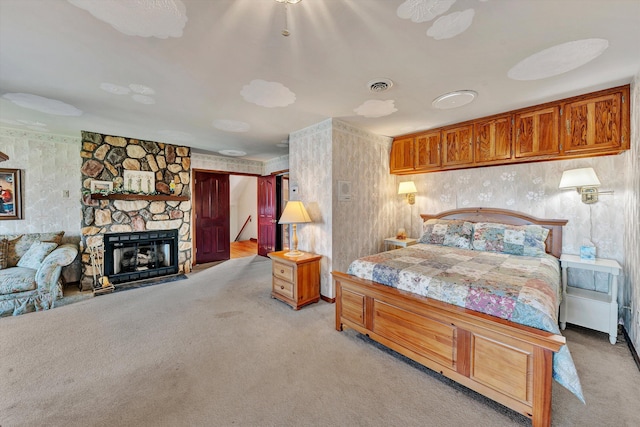 bedroom with light carpet and a fireplace