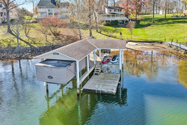 dock area with a water view and a lawn