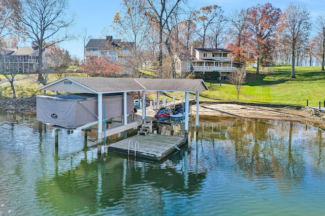 dock area featuring a water view and a lawn