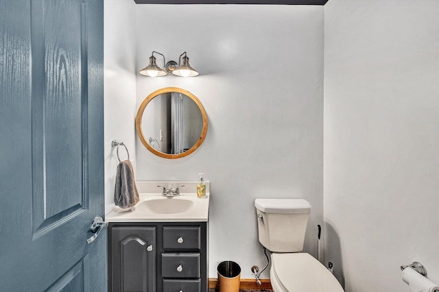 bathroom featuring vanity and toilet