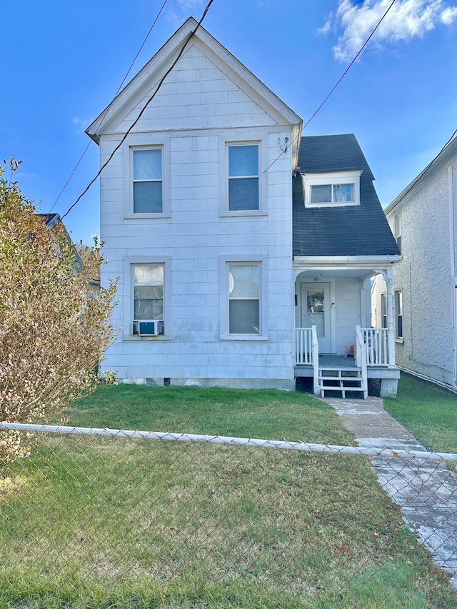 view of front facade featuring cooling unit and a front lawn