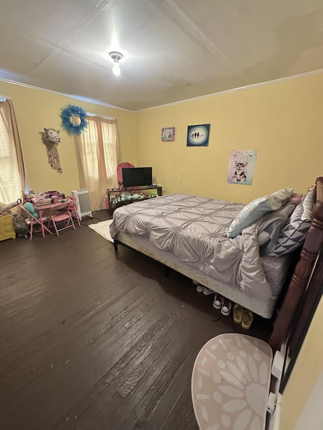 bedroom featuring crown molding and dark hardwood / wood-style flooring