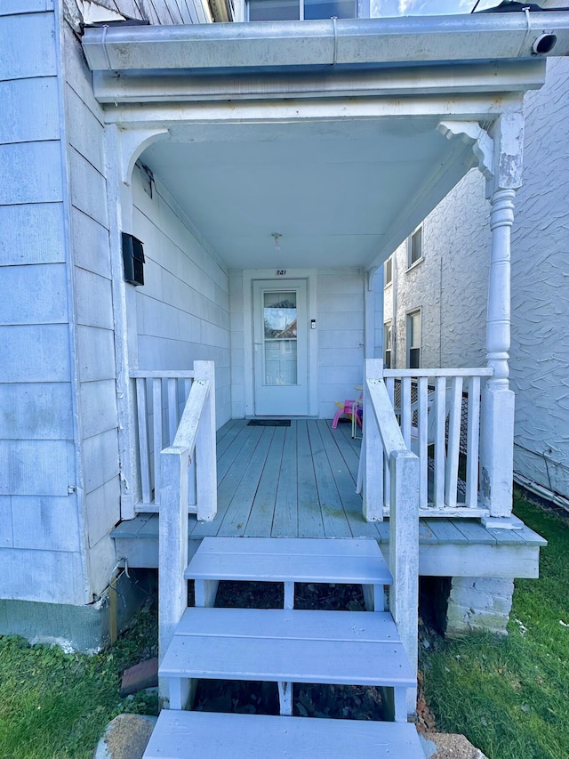 view of exterior entry featuring covered porch