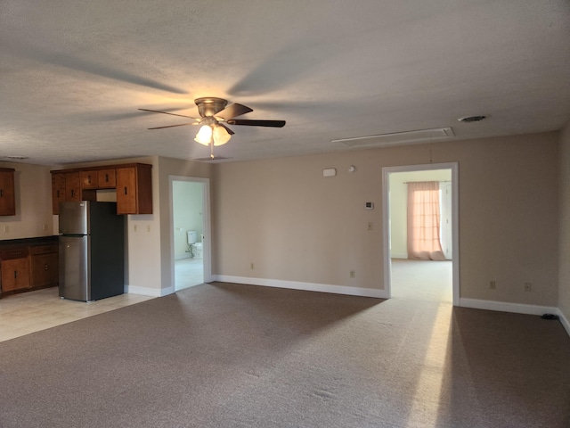 unfurnished living room featuring light carpet and ceiling fan