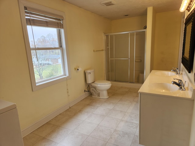 bathroom featuring a shower with shower door, vanity, and toilet