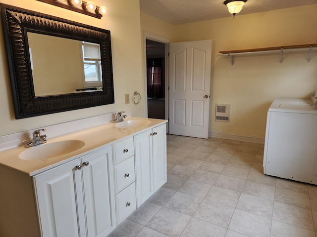 bathroom featuring heating unit, washer / clothes dryer, vanity, and tile patterned floors