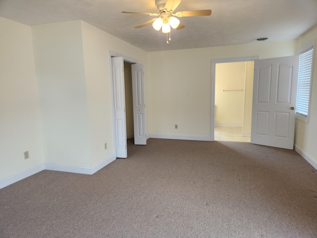 unfurnished room featuring light carpet and ceiling fan