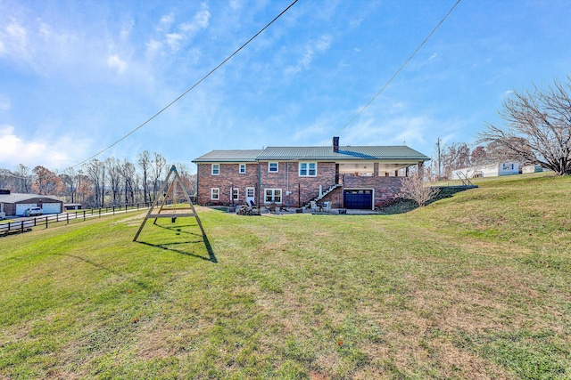 rear view of property with a yard