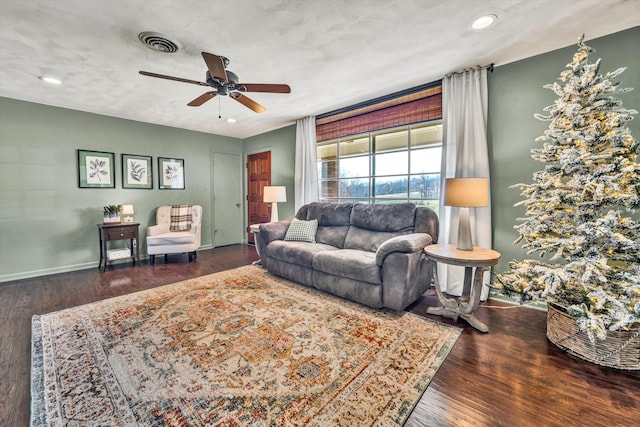 living room featuring a textured ceiling, dark hardwood / wood-style floors, and ceiling fan