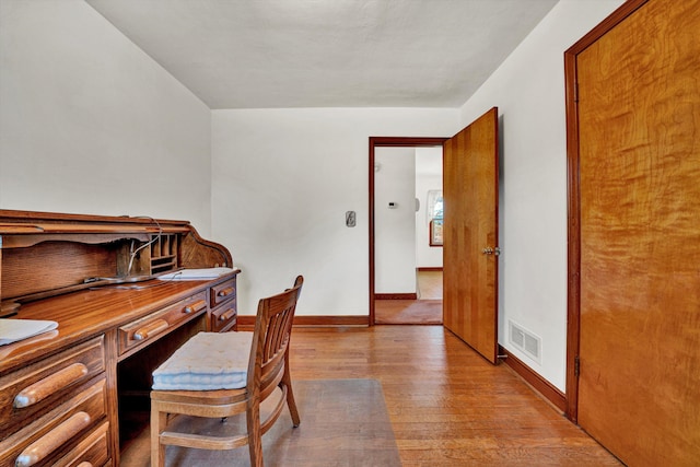 office area with light hardwood / wood-style floors