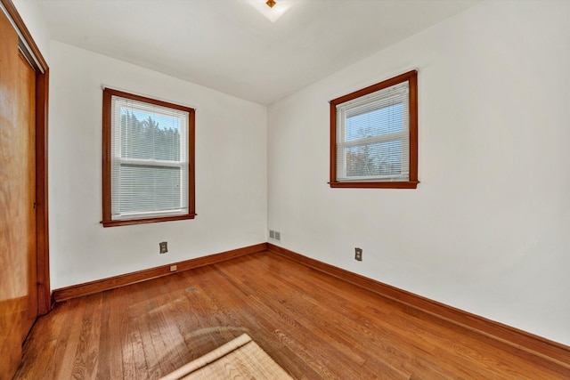 empty room with hardwood / wood-style flooring