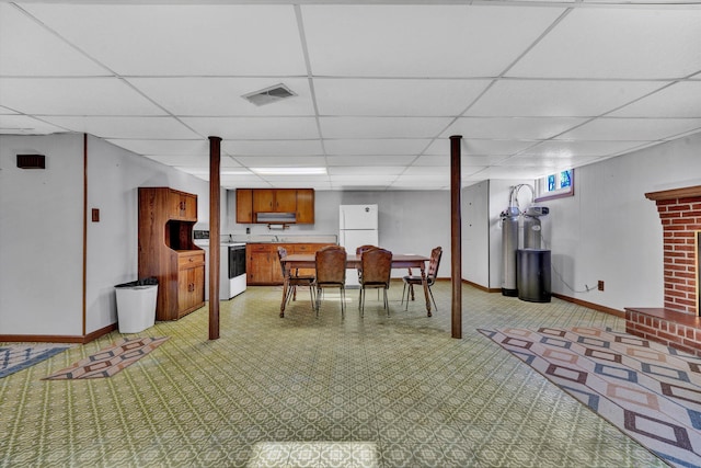 dining area with a paneled ceiling