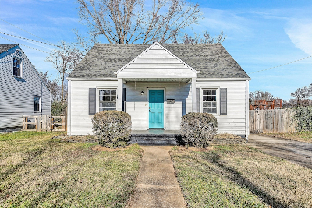 bungalow-style home featuring a front yard