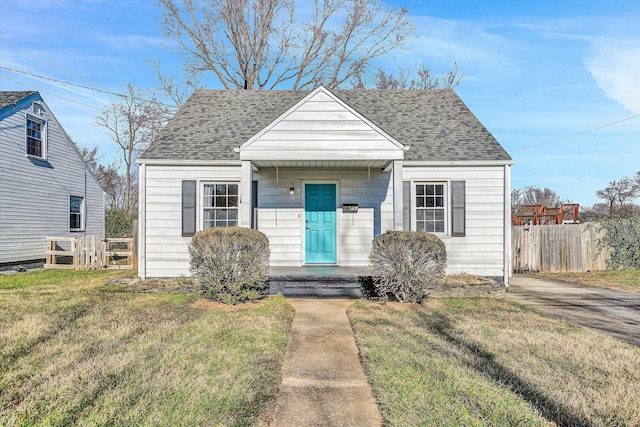 bungalow-style home featuring a front yard