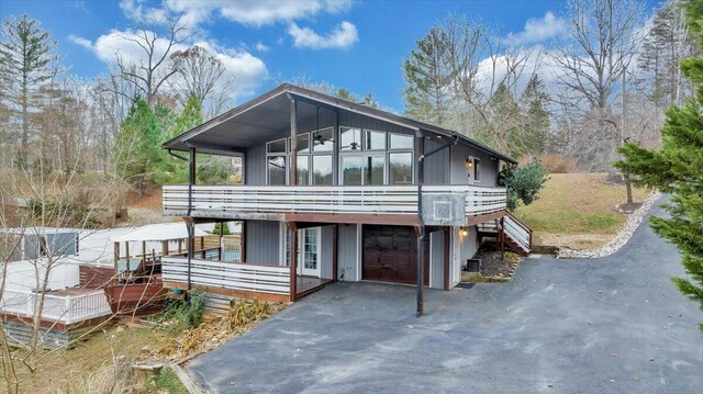 back of house featuring a garage