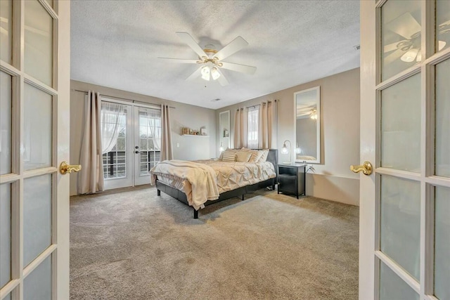 carpeted bedroom with access to outside, multiple windows, a textured ceiling, and french doors