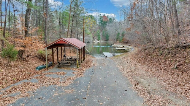 exterior space featuring a water view and a wooded view